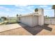 Rear exterior view of the home featuring a chimney, covered patio, and desert landscaping at 5155 Saratoga Dr, Las Vegas, NV 89120