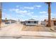 Front exterior view of home with gray paint, desert landscaping, and long driveway at 5155 Saratoga Dr, Las Vegas, NV 89120