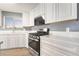 Well-lit kitchen featuring stainless steel appliances, white cabinetry, and a window providing natural light at 5155 Saratoga Dr, Las Vegas, NV 89120
