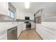 Well-lit kitchen featuring stainless steel appliances, ample counter space, and white cabinets at 5155 Saratoga Dr, Las Vegas, NV 89120