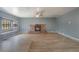 Cozy living room featuring a brick fireplace, tile flooring, and large window with sitting area at 5155 Saratoga Dr, Las Vegas, NV 89120