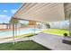 Covered patio with view of the backyard pool, grass, desert landscaping, and fenced perimeter at 5155 Saratoga Dr, Las Vegas, NV 89120