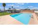 Backyard view showcasing a refreshing pool with ample deck space, lawn, and a covered patio at 5155 Saratoga Dr, Las Vegas, NV 89120