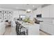 Modern kitchen with a large island, all-white cabinets, and stylish bar stools at 55 Strada Fontana, Henderson, NV 89011