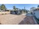 The property showcases a spacious backyard with gravel area, brick patio, and covered structure at 59 N Christy Ln, Las Vegas, NV 89110
