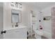 Bathroom featuring modern sink, toilet, combined bathtub and shower, and cabinet storage at 59 N Christy Ln, Las Vegas, NV 89110