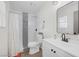 A modern bathroom with a shower-tub combination, stylish mirror, and tiled accents at 59 N Christy Ln, Las Vegas, NV 89110