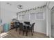 Bright dining area featuring a modern black table and chairs, with sliding glass doors at 59 N Christy Ln, Las Vegas, NV 89110