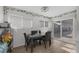 Bright dining area featuring a modern black table and chairs, adjacent to sliding glass doors at 59 N Christy Ln, Las Vegas, NV 89110