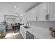 Kitchen includes stainless dishwasher, white cabinets and adjacent dining area at 59 N Christy Ln, Las Vegas, NV 89110