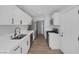 Kitchen features stainless appliances, white cabinetry, and wood style floors at 59 N Christy Ln, Las Vegas, NV 89110