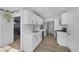 Bright kitchen with white cabinets, stainless appliances, and wood-look floors at 59 N Christy Ln, Las Vegas, NV 89110