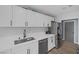 Updated kitchen boasts white cabinets, countertops and stainless appliances at 59 N Christy Ln, Las Vegas, NV 89110