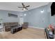 Large living room features bright blue walls, wood-look floors, and a comfortable gray sofa set at 59 N Christy Ln, Las Vegas, NV 89110