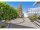 Paver patio surrounded by lush greenery and garden beds, creating a serene outdoor space at 636 H Ave, Boulder City, NV 89005