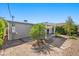 Relaxing backyard featuring a pergola, small palm tree, and gravel landscaping at 636 H Ave, Boulder City, NV 89005