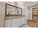 Bathroom with double vanity sinks, and a large walk-in closet organizer at 636 H Ave, Boulder City, NV 89005