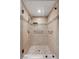 Tiled walk-in shower featuring glass doors, a rainfall showerhead and built-in shelving at 636 H Ave, Boulder City, NV 89005