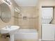 Well-lit bathroom with a shower-tub combination and a convenient washer and dryer at 636 H Ave, Boulder City, NV 89005