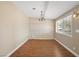Bright dining room with wood floors, shiplap accent wall, and modern chandelier at 636 H Ave, Boulder City, NV 89005