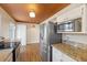 Updated kitchen with stainless steel appliances, granite countertops, and decorative ceiling at 636 H Ave, Boulder City, NV 89005