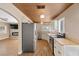 Open kitchen with stainless steel appliances and view of the living room fireplace at 636 H Ave, Boulder City, NV 89005