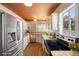 Well-lit kitchen featuring stainless steel appliances, ample counter space, and a decorative ceiling at 636 H Ave, Boulder City, NV 89005