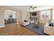 Bright living room with modern fireplace, neutral furniture, and hardwood floors open to dining room at 636 H Ave, Boulder City, NV 89005