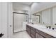 Modern bathroom featuring double sinks, a large mirror, and a sleek glass-enclosed shower at 659 Spotted Falcon St, Las Vegas, NV 89138