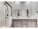 Bathroom with dual sinks, a spacious shower, and modern fixtures in neutral tones at 659 Spotted Falcon St, Las Vegas, NV 89138