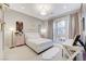 Bedroom with neutral colors, desk and large window at 659 Spotted Falcon St, Las Vegas, NV 89138
