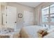 Cozy bedroom with a comfortable bed, large window and stylish chair with french graphic pattern at 659 Spotted Falcon St, Las Vegas, NV 89138
