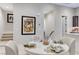 The open dining area showcases unique artwork and leads to a staircase and a modern kitchen at 659 Spotted Falcon St, Las Vegas, NV 89138