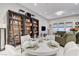 The open-concept dining area features custom bookshelves, a round table, and comfortable seating at 659 Spotted Falcon St, Las Vegas, NV 89138