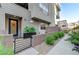 Inviting entrance to a townhome featuring a stylish blue front door and landscaped courtyard at 659 Spotted Falcon St, Las Vegas, NV 89138