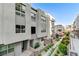 Charming townhome showcasing a light gray exterior with large windows and landscaped front yard at 659 Spotted Falcon St, Las Vegas, NV 89138