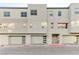Contemporary townhome complex featuring multiple units with modern garage doors and neutral exteriors at 659 Spotted Falcon St, Las Vegas, NV 89138
