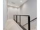 Upstairs hallway with carpet, featuring modern railings and neutral decor at 659 Spotted Falcon St, Las Vegas, NV 89138