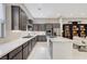 A modern kitchen featuring stainless steel appliances, grey cabinets, and a marble countertop island at 659 Spotted Falcon St, Las Vegas, NV 89138