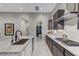 A modern kitchen featuring granite counters, stainless steel appliances, and a walk-in pantry for ample storage at 659 Spotted Falcon St, Las Vegas, NV 89138