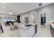 Modern kitchen with island, granite counters and open floor plan with adjacent dining and living areas at 659 Spotted Falcon St, Las Vegas, NV 89138