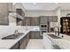 This contemporary kitchen offers sleek gray cabinetry, stainless appliances, and a stylish island with a marble countertop at 659 Spotted Falcon St, Las Vegas, NV 89138