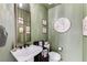 Stylish powder room featuring green walls, vintage decor, and a unique vessel sink at 659 Spotted Falcon St, Las Vegas, NV 89138