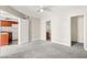 Bedroom with neutral walls and gray carpet, leading to the kitchen and bathroom at 6800 E Lake Mead Blvd # 1018, Las Vegas, NV 89156