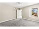 This bedroom features a ceiling fan, neutral walls, and a view of the outdoors at 6800 E Lake Mead Blvd # 1018, Las Vegas, NV 89156