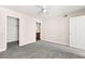 This bedroom offers soft carpet, a ceiling fan, and ensuite bath with wood-style floors at 6800 E Lake Mead Blvd # 1018, Las Vegas, NV 89156