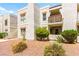 Attractive condominium complex with stucco exterior, balcony, and tidy landscaping at 6800 E Lake Mead Blvd # 1018, Las Vegas, NV 89156