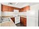 Kitchen with wooden cabinetry, granite countertops, and stainless steel sink at 6800 E Lake Mead Blvd # 1018, Las Vegas, NV 89156