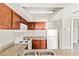 Kitchen with wood cabinets, granite countertops, and white appliances at 6800 E Lake Mead Blvd # 1018, Las Vegas, NV 89156