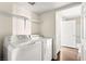 Laundry room features newer appliances, a shelf, and wood-style flooring at 6800 E Lake Mead Blvd # 1018, Las Vegas, NV 89156